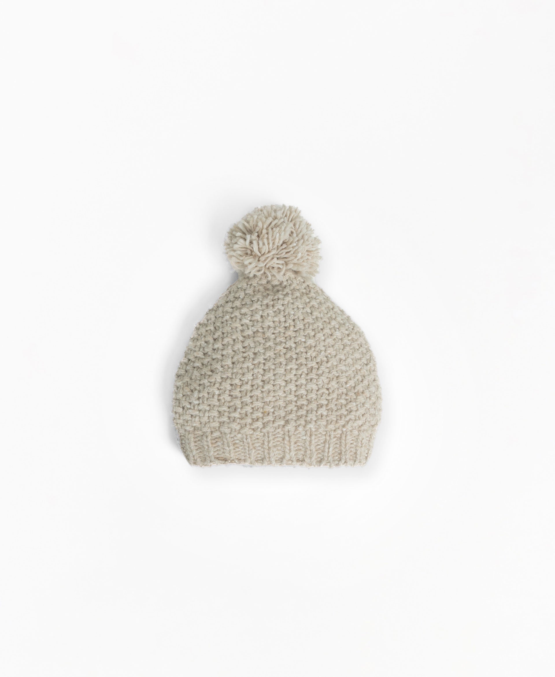 Knitted beanie with pompom on top
