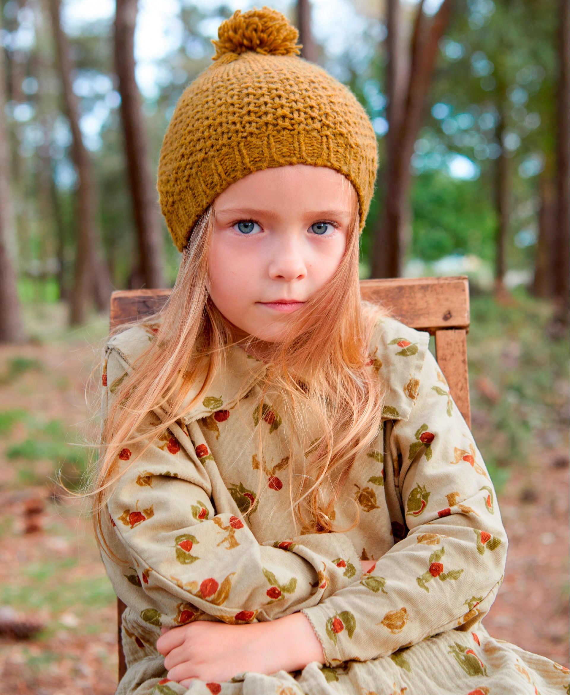 Knitted beanie with pompom on top