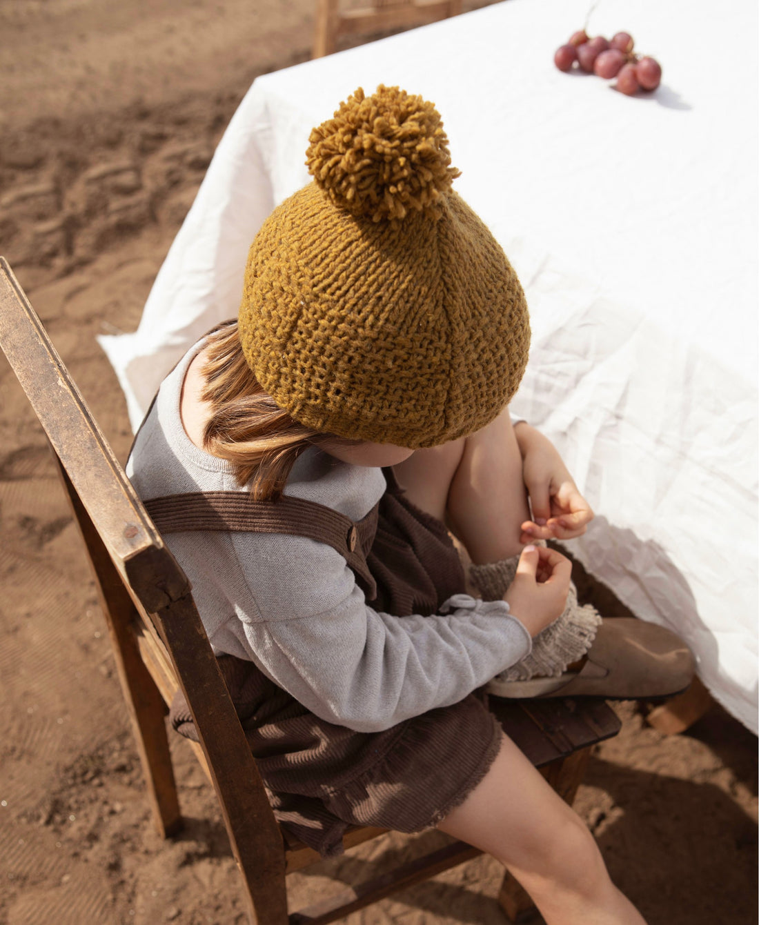 Knitted beanie with pompom on top