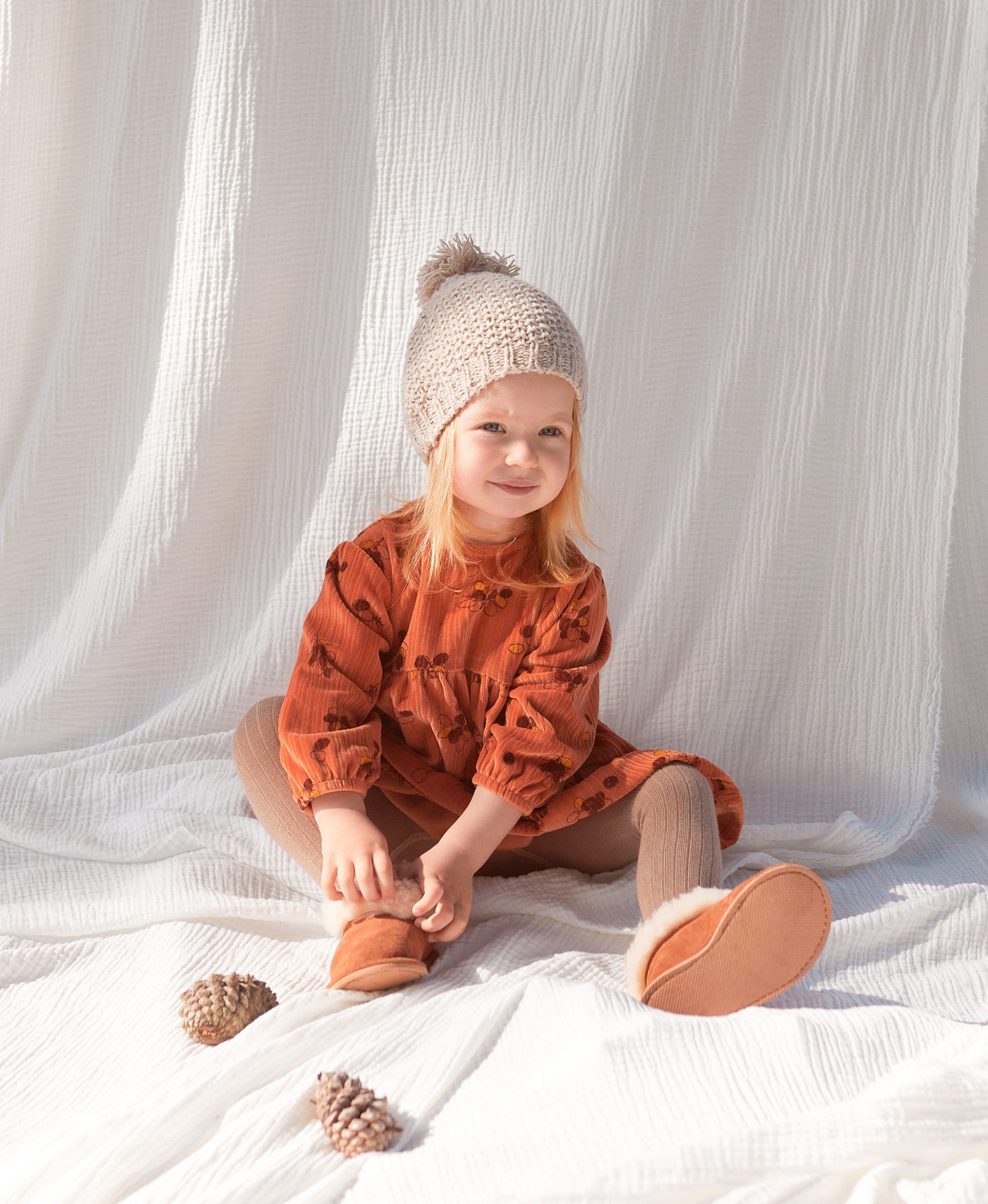 Knitted beanie with pompom on top